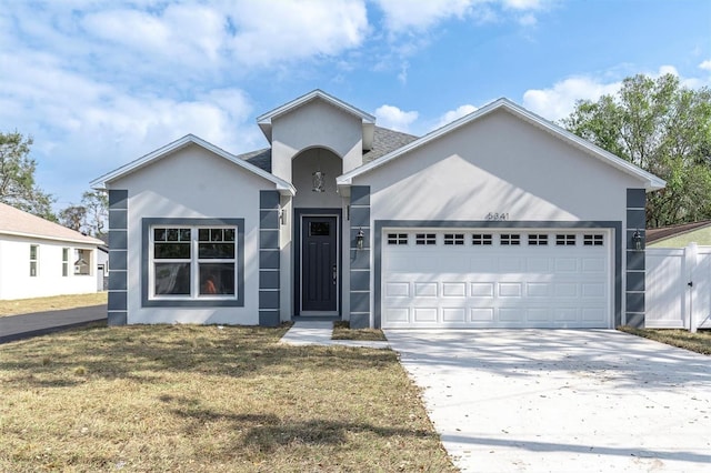 view of front of house with a garage and a front lawn