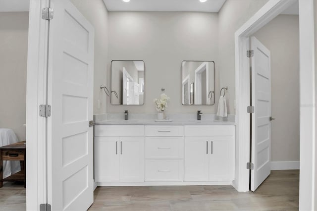 bathroom featuring hardwood / wood-style flooring and vanity