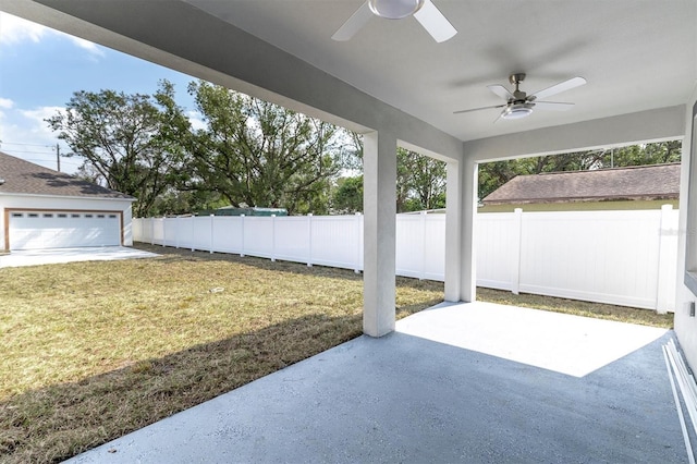 view of patio featuring ceiling fan and a garage