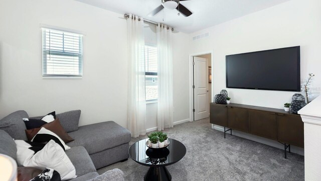 living room featuring a healthy amount of sunlight, light carpet, and ceiling fan