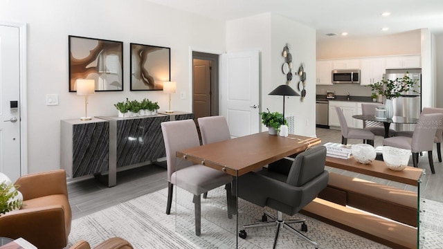 dining space with light hardwood / wood-style floors