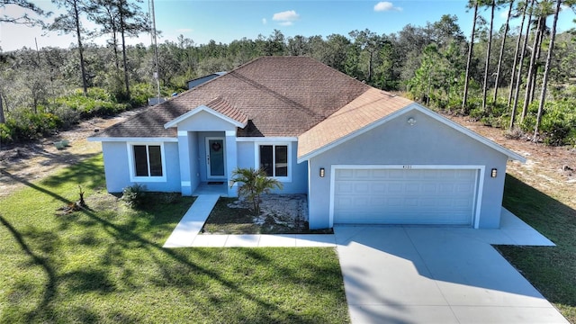 view of front of home with a garage and a front lawn