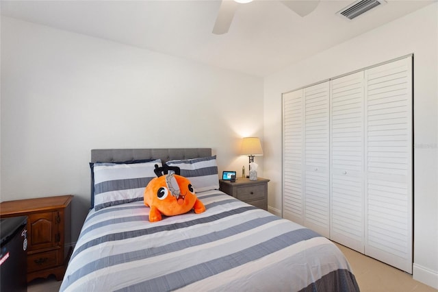 bedroom with ceiling fan and a closet