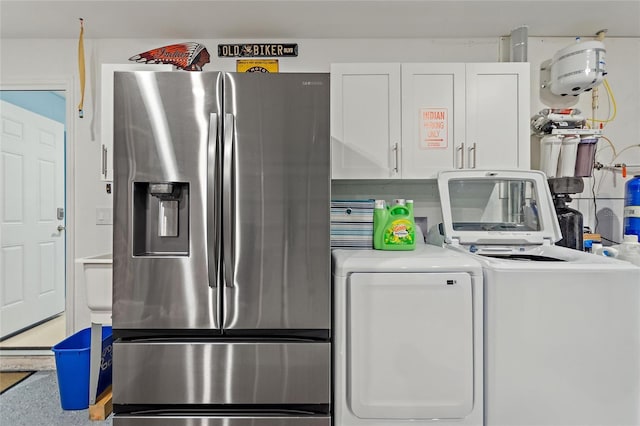 washroom with cabinets and washer and dryer