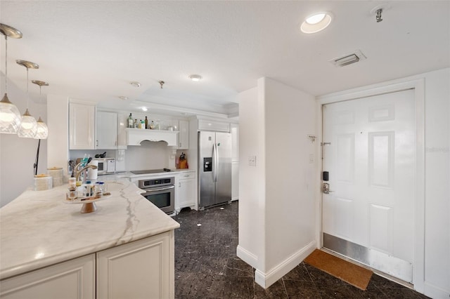 kitchen with light stone counters, hanging light fixtures, stainless steel appliances, and white cabinets