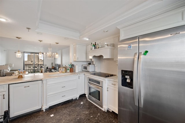 kitchen featuring hanging light fixtures, stainless steel appliances, a raised ceiling, and white cabinets