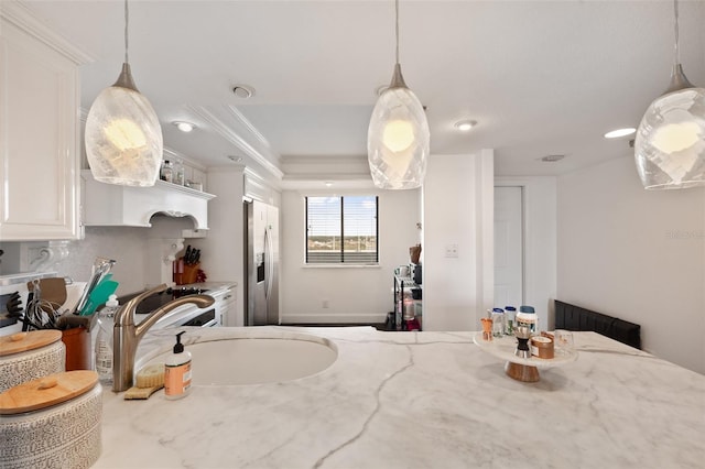 kitchen with tasteful backsplash, light stone countertops, stainless steel fridge with ice dispenser, and white cabinets