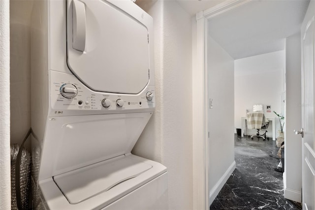 laundry area with stacked washer / dryer