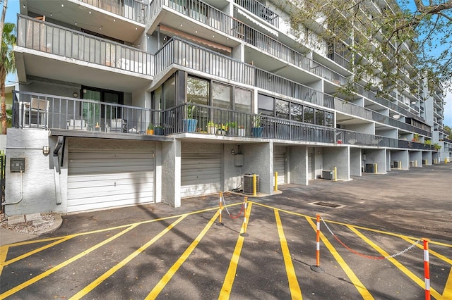 view of property featuring a garage and central air condition unit