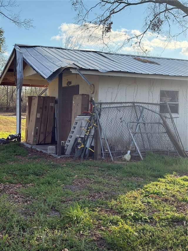 view of outbuilding featuring a lawn