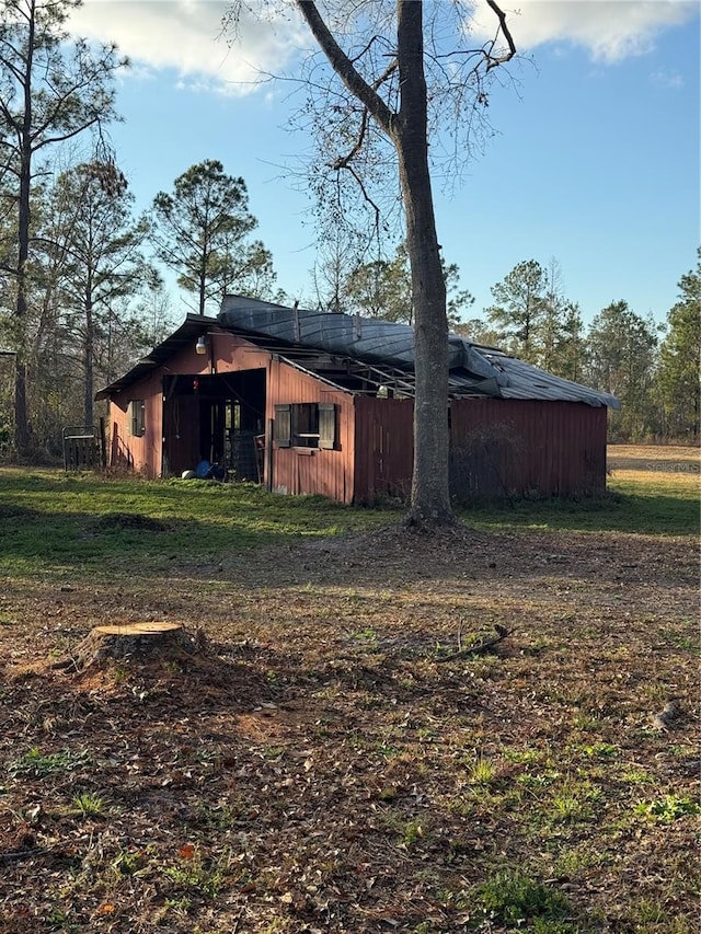 view of side of property featuring an outbuilding