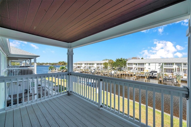 deck with a water view and a yard