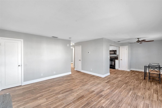 living room with ceiling fan and light hardwood / wood-style flooring