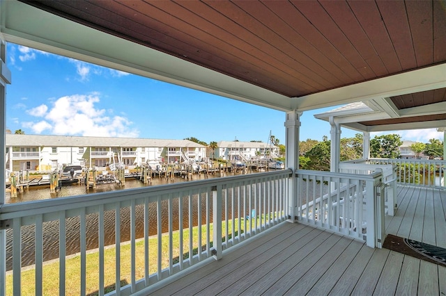 wooden terrace featuring a water view