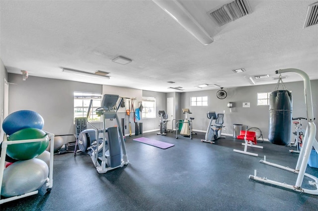 workout area featuring a textured ceiling