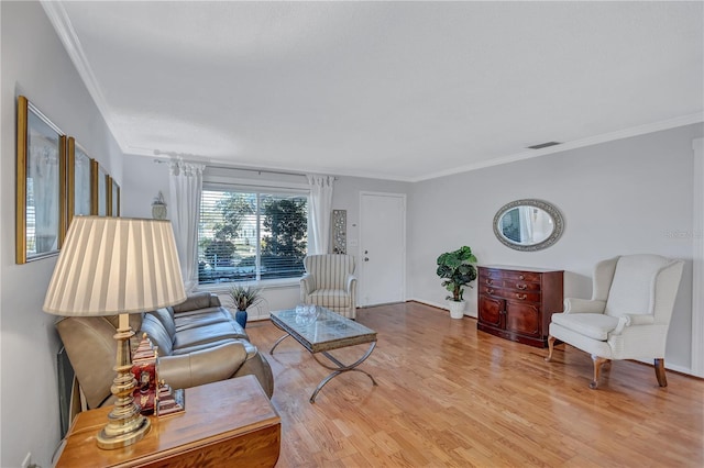 living room with crown molding and light wood-type flooring