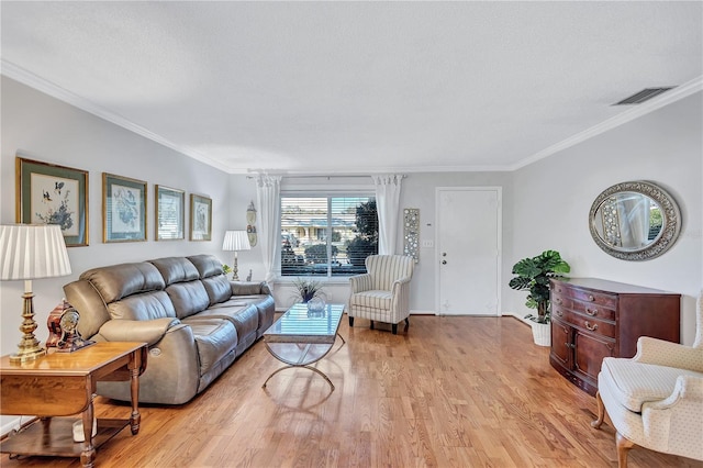 living room with crown molding, a textured ceiling, and light hardwood / wood-style floors