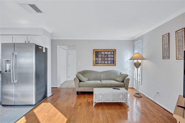 living room featuring crown molding and light wood-type flooring