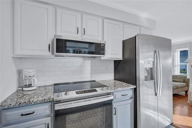 kitchen featuring white cabinetry, appliances with stainless steel finishes, and backsplash