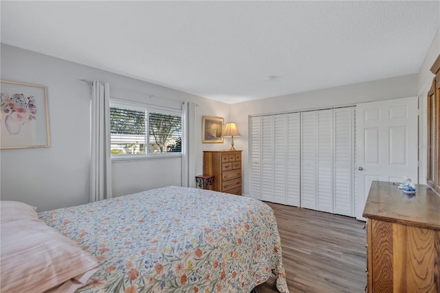 bedroom featuring hardwood / wood-style flooring and a closet