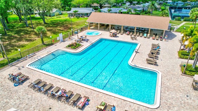 view of swimming pool featuring a community hot tub and a patio area