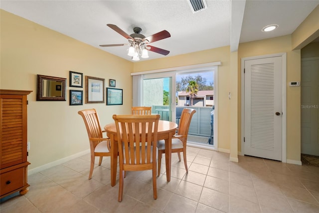 tiled dining space with ceiling fan