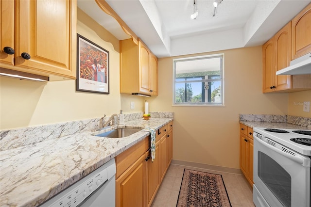 kitchen with light tile patterned flooring, sink, light stone counters, light brown cabinets, and white appliances