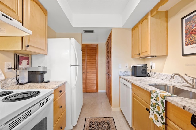 kitchen featuring sink, light tile patterned floors, light brown cabinets, white appliances, and light stone countertops