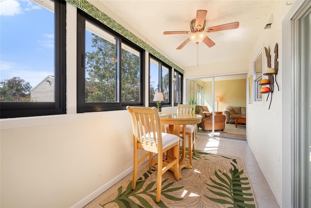 sunroom featuring ceiling fan