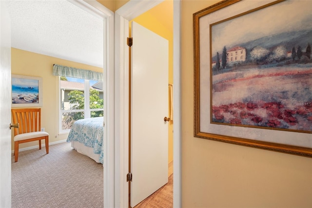 hallway with light colored carpet