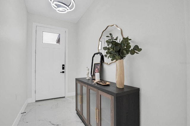 foyer entrance featuring an inviting chandelier