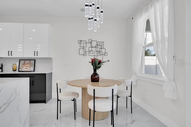 dining area with an inviting chandelier