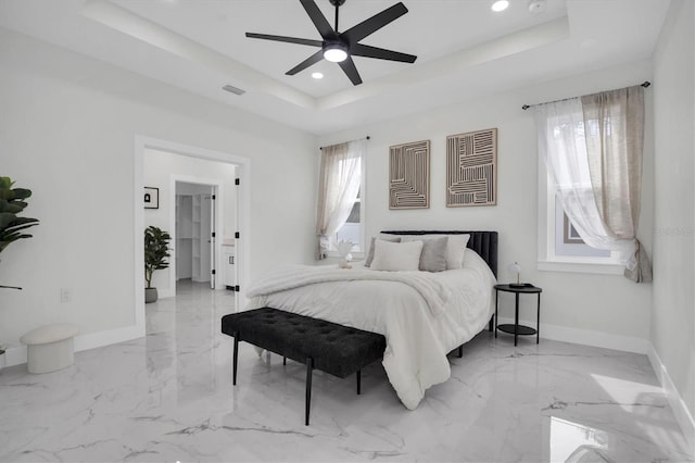 bedroom featuring a tray ceiling and ceiling fan