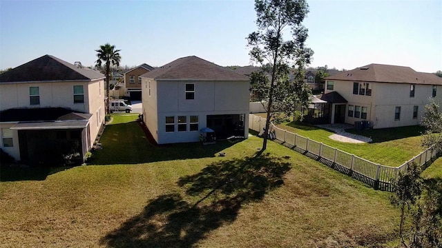 rear view of property with a lawn