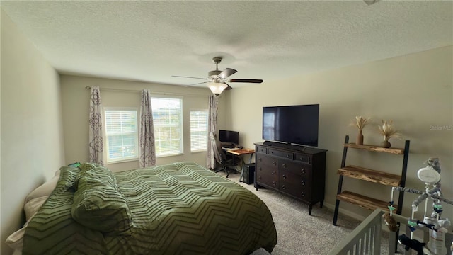 bedroom featuring ceiling fan, light carpet, and a textured ceiling