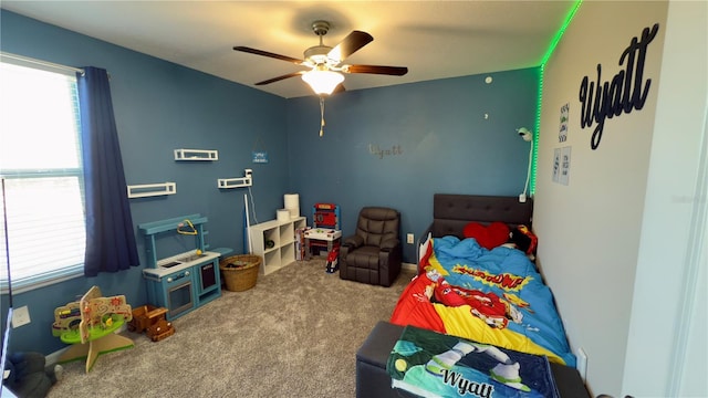 bedroom with ceiling fan and carpet flooring