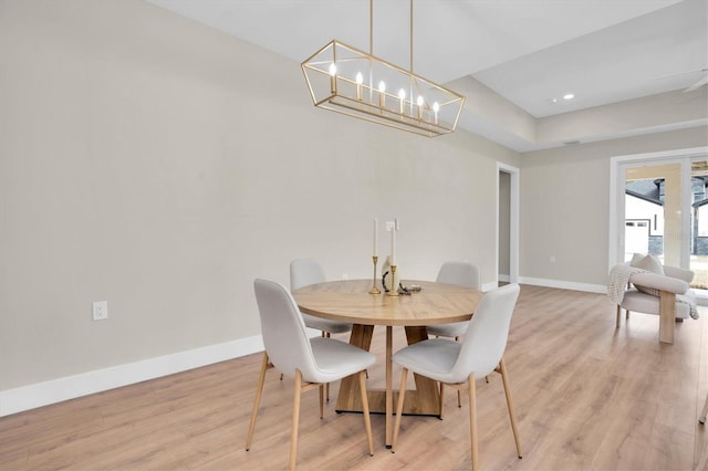 dining room featuring a chandelier and light hardwood / wood-style flooring