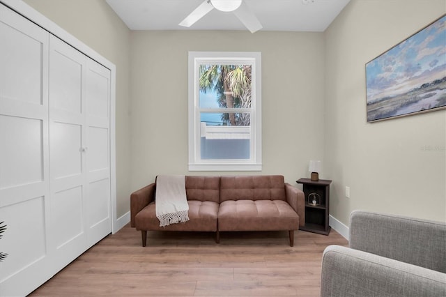 sitting room with ceiling fan and light hardwood / wood-style floors