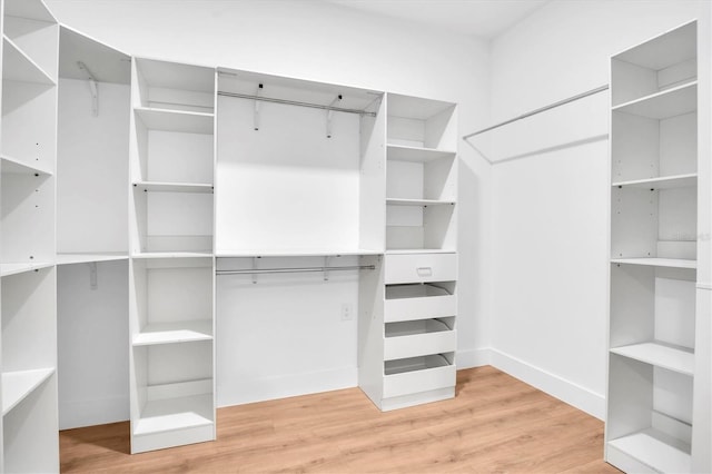 walk in closet with hardwood / wood-style floors