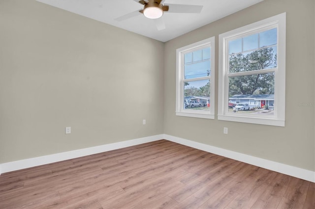 spare room with ceiling fan and light wood-type flooring