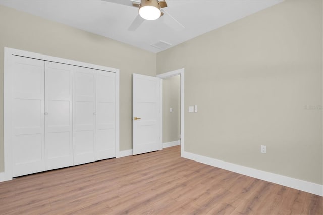 unfurnished bedroom with ceiling fan, a closet, and light hardwood / wood-style flooring