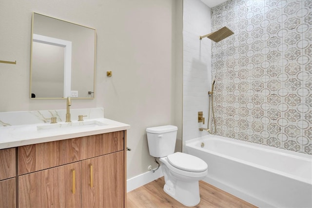 full bathroom with vanity, hardwood / wood-style floors, tiled shower / bath, and toilet