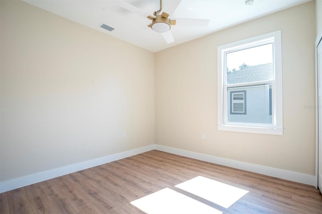 empty room featuring ceiling fan and light wood-type flooring