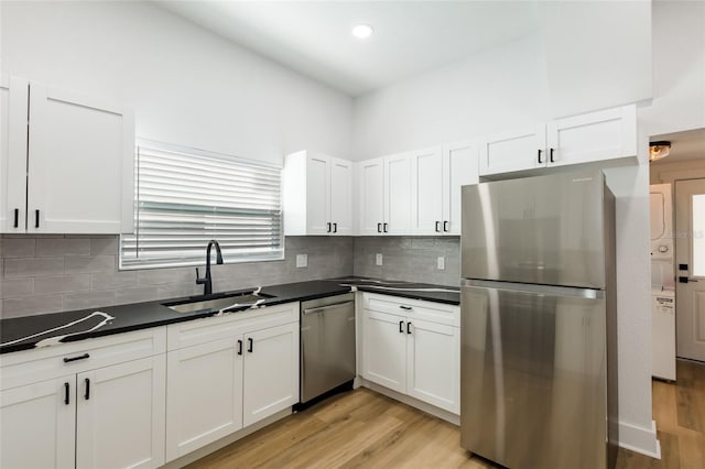 kitchen featuring white cabinetry, sink, and stainless steel appliances