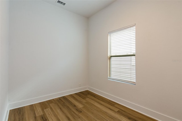 empty room with hardwood / wood-style floors