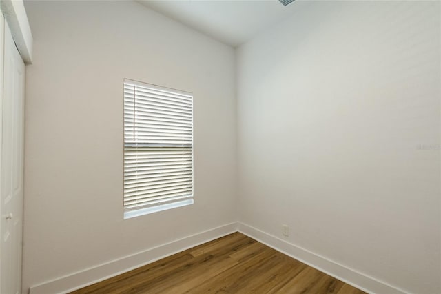 unfurnished room with wood-type flooring