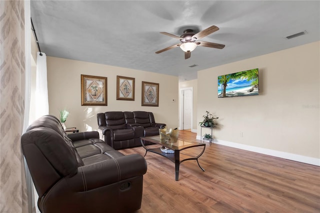 living room featuring hardwood / wood-style flooring and ceiling fan