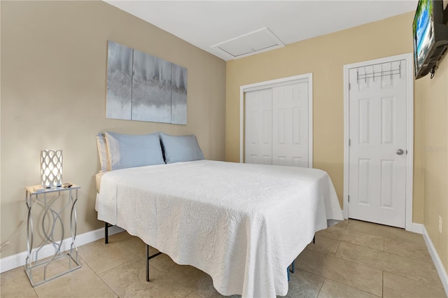 bedroom with light tile patterned floors and a closet