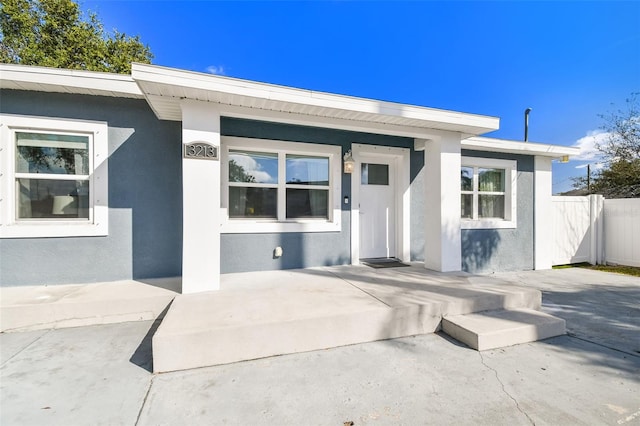 entrance to property with a patio