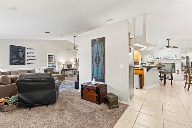 tiled living room with lofted ceiling and ceiling fan